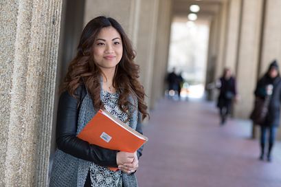 picture of a Centennial College International Education student standing outside with a portfolio